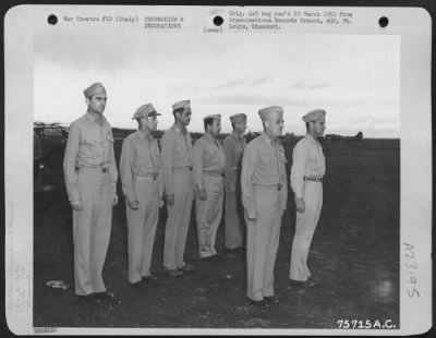 Consolidated > Major General Nathan F. Twining (Front Row, Left) And Brig. Gen. Dean C. Strother (Back Row, Left) Stand With Officers Of The 94Th Fighter Squadron, 1St Fighter Group During A Review At An Airfield Somewhere In Italy.