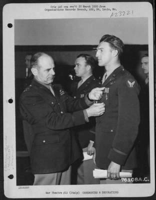 Consolidated > Major General James H. Doolittle Awards The Distinguished Flying Cross To An Officer Of The 90Th Photo Reconnaissance Wing During A Ceremony At An Air Base Somewhere In Italy.