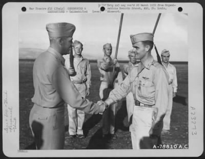 Consolidated > Major General Nathan F. Twining Presents The Distinguished Flying Cross To A Member Of The 94Th Fighter Squadron, 1St Fighter Group During A Ceremony At An Airbase Somewhere In Italy.