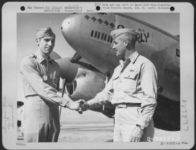 Consolidated > Major General Nathan F. Twining Presents The Legion Of Merit To A Member Of The 94Th Fighter Squadron, 1St Fighter Group During A Ceremony At An Airbase Somewhere In Italy.