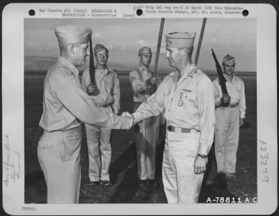 Consolidated > Major General Nathan F. Twining Presents The Air Medal And The Purple Heart To A Member Of The 94Th Fighter Squadron, 1St Fighter Group During A Ceremony At An Airbase Somewhere In Italy.