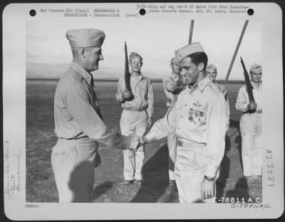 Consolidated > Major General Nathan F. Twining Presents An Award To A Member Of The 94Th Fighter Squadron, 1St Fighter Group During A Ceremony At An Airbase Somewhere In Italy.