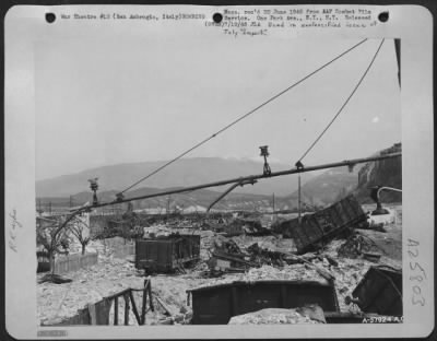 Consolidated > Marshalling yards at San Ambrogio, Italy after bombing by 15th AF bombers. The entrance to the Brenner Pass may be seen in the background. June 1945.