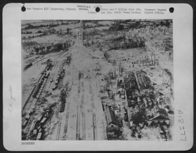 Thumbnail for Argentan > Argentan, France, marshalling yard shown in this "TAC/R" photograph, which was taken by 9th Air Force photographers, after repeated attack from Allied fighter-bombers. Motor column on road at upper right is one of the first American convoys to enter