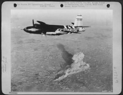 Thumbnail for Armentieres > It's a mission completed, this Ninth Air Force Marauder medium bomber turns for its home base above the smoking railway yard at Armentieras in Northern France. The target, located in the French town, was bombed recently in a late evening mission to