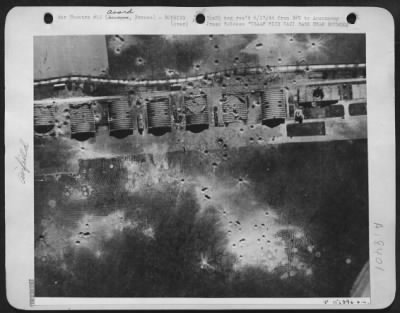 Thumbnail for Avord > Four large hangars and a workshop, all neatly aligned at the Avord airfield near Bourges in occupied France were damaged by dired hits from heavy bombers of the U.S. Army 8th Air Force. Note bomb craters dotting the area.