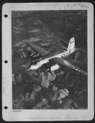 Thumbnail for Beauvais/Tille > Luftwaffe Nemisis-Here you see a "Silver Streak" Martin B-26 Marauder medium bomber of the 9th AF leaving the Nazi airfield at Beauvais Tille in France, after a recent attack by the Marauders. A large dispersal area took a heavy pounding during the