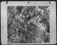 Belfort railyards, France after bombing by 8th Air Force on 11 Aug 44. Cumulative results show locomotive shops almost totally destroyed, trans-shipment shed and station shattered, all thorugh lines cut. - Page 1