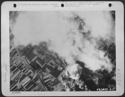 Consolidated > CRIPPLING NAZI RAILROAD COMMUNICATIONS-The railway marshalling yards at Chalons, France are enveloped in smoke and explosions after being hit by the bombs of 8th AF heavies. Note in lower right, huge explosions just beginning to erupt angrily