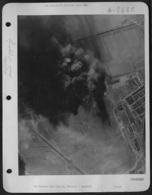 Thumbnail for Dijon > Billows of smoke shrouds the Luftwaffe's twin-engine fighter base at Dijon in eastern France as American heavy bombers took their toll of four hangars damaged or destroyed and hits on the main workshops, three smaller hangars and the barracks area