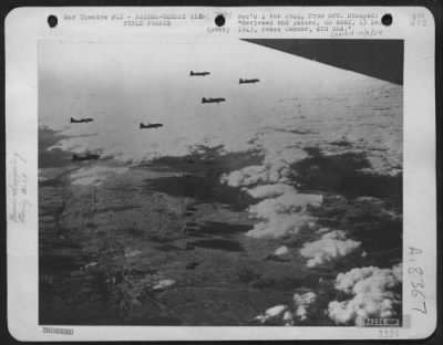 Thumbnail for Amiens > Left Flight, Dropping Bombs Over Amiens-Glissy Airfield.  Seven Sticks Of Bombs Can Be Counted In The Air.  Aug 31 1943.