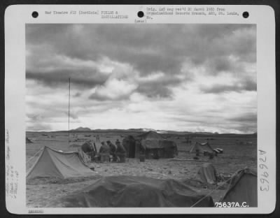 Thumbnail for Consolidated > Members of the 94th Fighter Squadron, 1st Fighter Group sit outside their tents and discuss events of the day at their air base in Sardinia.