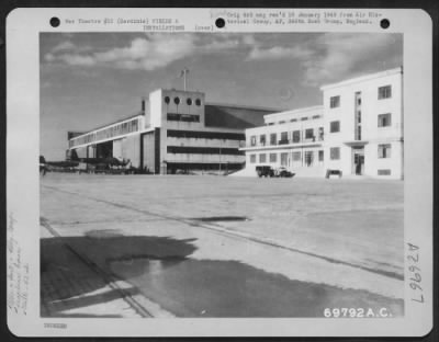 Thumbnail for Consolidated > View of large seaplane hangar (left) and headquarters building of the 42nd Wing (right) at Elmas, Sardinia. 24 November 1943.