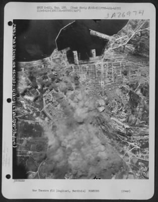 Thumbnail for Consolidated > Smoke rises from installations at Cagliari, Sardinia after planes of the 97th Bomb Group, 414th Bomb Squadron, 15th Air Force have dropped their bombs on 13 May 1943.