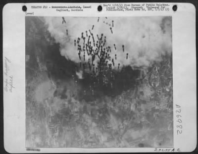 Thumbnail for Consolidated > This picture which was made from a Boeing B-17 "Flying Fortress" shows bombs falling on the Monserrato Airfield, near Cagliari, in Sardinia. Recent raids by the Boeing B-17's have caused considerable damage to German and Italian planes and equipment