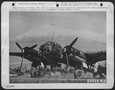 Thumbnail for Consolidated > Axis Calendar Out of Date-This photo of a Stuka dive-bomber against the background of Mt. Etna, near Catania, Sicily was originally reproduced in color on thousands of German calendars. It typified with characteristic Axis arrogance the belief that