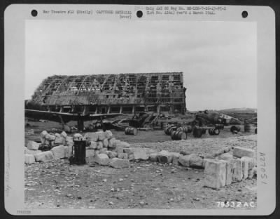 Consolidated > Wrecked hangar and German planes at an airfield near Trapani, Sicily after complete pulverization by American bombers. 26 July 1943.