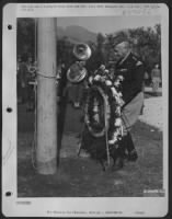 Commemorating the first Armistice day on Axis soil, Lt. Gen. George S. Patton, Commanding Gen. 7th Army, places a wreath on the flag pole in an american war cemetery at Palermo, Sicily. - Page 1
