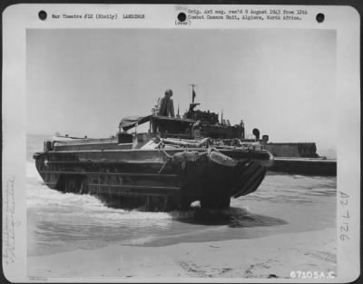 Thumbnail for Consolidated > A "duck," loaded with oil drums destined for a supply dump at Gela, Sicily, crawls out of the water onto the beach. July 1943.