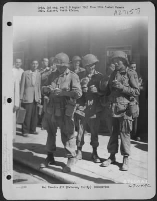 Thumbnail for Consolidated > "Ice Cream is always a treat" is the conclusion of three paratroopers eating it on the sidewalks of Palermo, Sicily. They are, left to right: Pvt. D. Rice of Gary, Indiana; Cpl. J. Fowler of Pittsburgh, Pennsylvania; and Pvt. F.S. Cole of Brooklyn