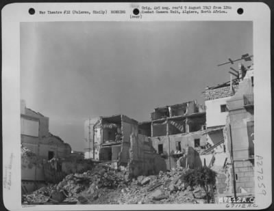 Thumbnail for Consolidated > Before Allied bombing attacks, this mass of rubble was an apartment house in Palermo, Sicily. The small dump cars in the left foreground were used to haul some of the debris away. July 1943.