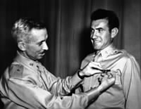 , Brigadier General Isaiah Davies pins a pair of silver bombardier wings on Lieutenant Lou Zamperini.jpg