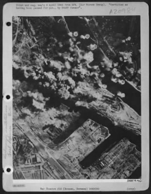 Consolidated > GOOD VIEW OF BREMEN---Aided by perfect visibility, bombs of the 381st Bombardment Group strike at submarine pens and harbor installations at Bremen, Germany, 30 Mar. 45. This was one of several targets hit by a force of more than 1400 Consolidated