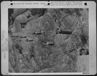 Consolidated > TARGET BOUND--Incendiaries and high explosives streak earthward for the Nazi rail centers at Bruchsal, Germany, during the large scale daylight attack 1 March 1945 by U.S. 8th AF heavy bombers. It was the 14th consecutive day of huge bombing forces