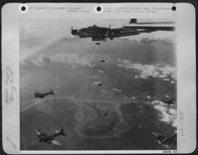Consolidated > Boeing B-17 Flying Fortresses release their bomb loads over the Darmstadt, Germany marshalling yards during an 8th Air Force daylight attack on one of the enemy's important communication centers supplying the western front.