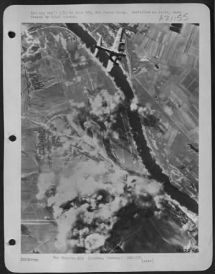 Consolidated > One bomber of the second wave of attacking Boeing B-17 Flying Fortresses, soars over the inferno of smoke surging upward from the German underground oil storage depot at Derben, 14 January 1945, as second wave of U.S. 8th Air Force heavies close in