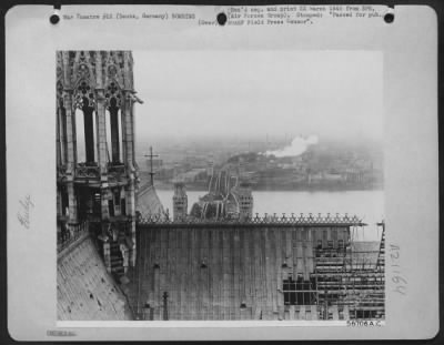 Consolidated > From his vantage point atop the Cathedral of Cologne, a 9th AF photographer obtained this view of Deutz, Germany, showing the destroyed Hohenzollern bridge across the Rhine and a fire in the background.
