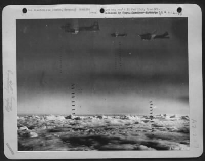 Consolidated > Taken from an 8th Air Force Bomber Command Boeing B-17 Fortress during an attack on the important port of Emden, 2 October, 1943, shows three Flying Fortresses over the target for "bomb away." In the foreground two sticks of bombs just begin to nose