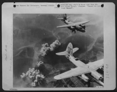 Consolidated > Striking in aerial cooperation with the 7th Army offensive into the Saar Palatinate, American Martin B-26 Marauders of the 1st Tac. AF leave gushing clouds of smoke hovering over the German town of Erlenbach, an enemy strong point in the Siegfried