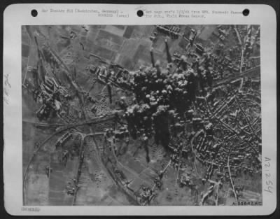 Consolidated > For the sixth consecutive day, U.S. 8th Air Force heavy bombers struck at Nazi supply lines feeding Rundstedt's divisions just behind the battle lines. Here smoke from heavy concentrations of bombs cover the rail marshalling yards at Euskirchen