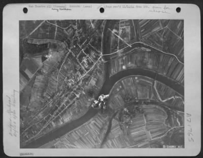 Consolidated > Bomb bursts completely cover the Konz-Karthaus rail bridge over the Moselle River, five miles southwest of Trier, Germany, after it was bombed by U.S. Army 9th Air Force Marauders.