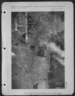 Consolidated > GERMANY-As smoke from previous hits rises from the target area, more bombs from U.S. 8th AF Consolidated B-24 Liberators crash down onto the Nazi airfield at Lachen/Speyerdorf, near Mannheim, 3 Oct 44, as the second wave of planes attacked.