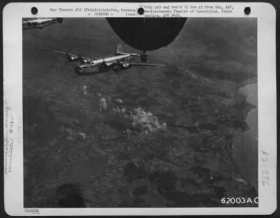 Consolidated > Bomb Bursts On The Target At Friedrichshafen, Germany, As Consolidated B-24 Liberator Of The 15Th Af Turns Homeward.  16 August 1944.