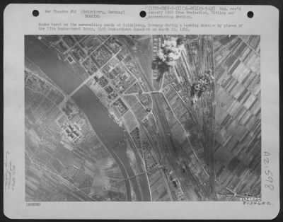Consolidated > Bombs Burst On The Marshalling Yards At Heidelberg, Germany, During A Bombing Mission By Planes Of The 17Th Bombardment Group, 34Th Bombardment Squadron On March 23 1945.