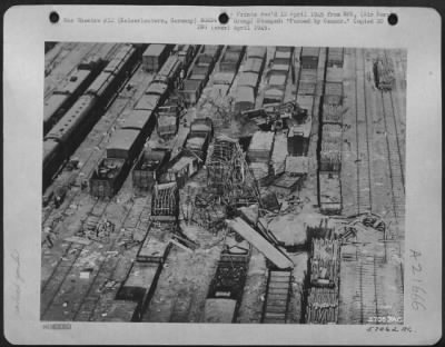 Consolidated > The Devastation Shown Here Is In The Kaiserslautern, Germany Railroad Yard.  Gutted Frameworks Of Cars, Torn And Twisted Trackage, Cars Displaced And Thrown Atop Adjacent Rolling Stock, Debris Scattered Throughout The Yard Are Evidence  Of The Effectivene