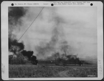 Consolidated > When The Japanese Air Force Finally Struck At 'Broadway', Burma, They Caught One North American P-51 Of The 1St Air Commando Force, Attempting To Take-Off; The Plane Is Burning In The Center Of The Field. The Plane Burning At Right Is A British 'Spitfire.