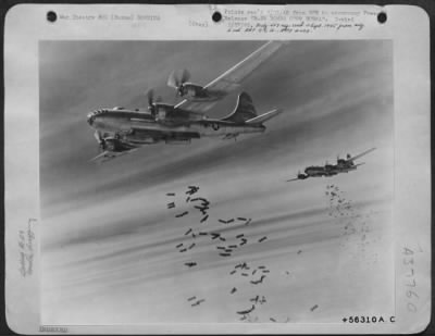 Consolidated > B-29 Bombs Over Burma (No.1) - Tons Of Bombs Speckle The Sky Over Rangoon, Burma, As They Spew From The Yawning Bomb Bays Of 20Th Bomber Command Superfortresses.  The Target Of This Daylight Attack By Brig. Gen. Roger M. Ramsey'S India-Based Airman Was A