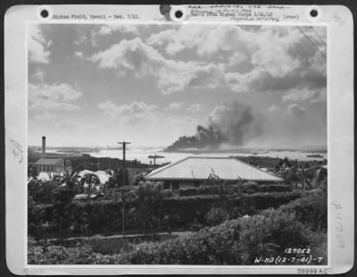 Consolidated > One Of The First Army Photos Of The Bombing Of Hawaii By The Japanese, Dec. 7, 1941.   The Battleship 'Arizona' On Fire And Sinking In Pearl Harbor After The Raid By Japanese Bombers.  Taken From Aexia Heights, T.H.