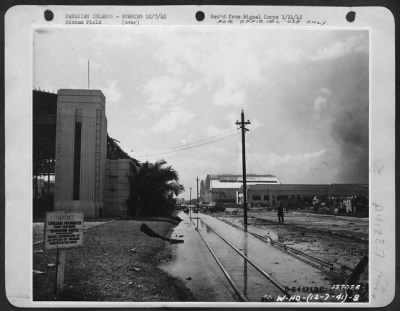 Thumbnail for Consolidated > Hawaiian Islands - Bombing 12/7/41 - Hickam Field, First Army Photos Of Bombing Of Hawaii, Dec. 7, 1941. Looking South Down Hanagr Avenue With Largest Hangars In Background Damaged By Fire. Hickam Field, Hawaii.