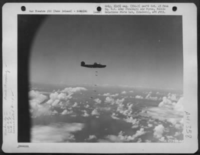 Consolidated > Bombs Fall From Consolidated B-24 Liberator During Raid Over Wake Island On 30 April 1944.  Airplanes Of The 11Th And 30Th Bomb Groups, 7Th Bomber Command, Participated In This Raid.