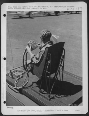 Thumbnail for Consolidated > Metal Stick Operator T/Sgt. L.D. Arris Of 1017 W. 3Rd St., Los Angeles, Calif., Guides A Radio Controlled Plane From His Position On Top Of Radio Control Truck.  Three Culver Pq 8A "Red Foxes" Are In The Background.  Oahu, Hawaii, April 1945.  (Wheeler Fi