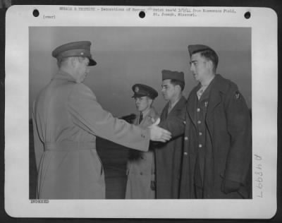 Groups > Receives Awards - Lt. Colonel William B. Hooton, Commanding Officer, Rosecrans Fields, 1St Operational Training Unit, Ferrying Division, Atc, St. Joseph, Mo., Congratulates Sgt. Francis W. Whitley Of Jerseyville, Ill., After Presenting The Sgt. With The D