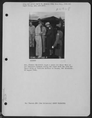 Groups > Mrs. Eleanor Roosevelt Signs A Paper For Major Wolf Of Air Transport Command During Her Visit With The 13Th Air Depot Group At Tontouta Airbase In Noumea, New Caledonia. 25 August 1943.