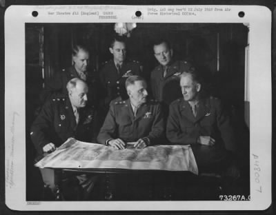 Groups > General Spaatz Confers With Other Generals Of His Command At An Air Base In England.  They Are, Left To Right: Major General Ralph Royce, Lt. General Carl Spaatz, Major General Hugh J. Knerr.  Standing, Left To Right: Brig. Gen. Edward P. Curtis, Major Ge