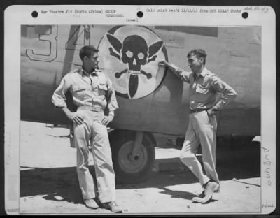 Groups > 1Lt James W. Welsh, Jr., Of St. Augustine, Fla., Co-Pilot And 1Lt John E. Mcatee, Of San Francisco, Calif., Pilot, Lean Against Side Of One Of The B-24S They Fly On Combat Missions.  Between Them Is Shown The Skull And Crossbone Insignia Of Their Squadron