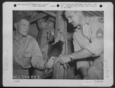 Groups > Tsgt Fred D. Randall Of Amarillo, Texas, Engineer Of A Liberator Struck By Enemy Ack-Ack Over Italy Shows 1Lt Melvin E. Neef Of Houstonia, Missouri, The Pilot, How He Closed The Hydraulic Line With Pliers, While Being Drenched With Gasoline From The Punct